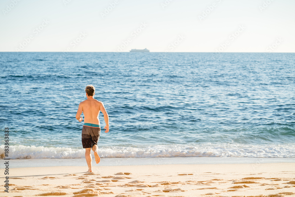 Man running on the beach in Portugal