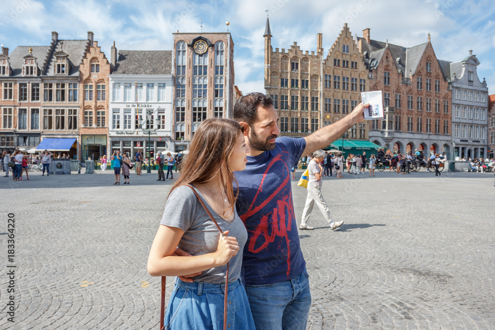 Young couple of tourists walking the streets of a European city.