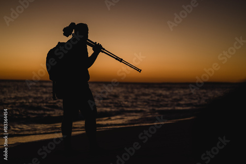Cameraman on the beach in Portugal at sunset