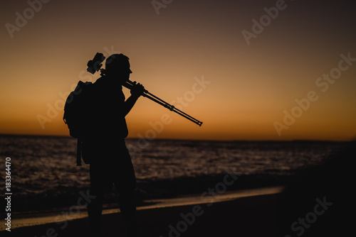 Cameraman on the beach in Portugal at sunset