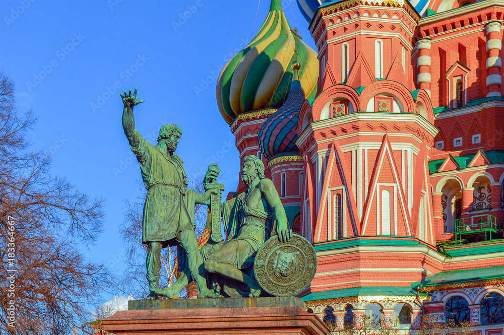 Monument to Minin and Pozharsky on Red square with St. Basil Blazhenny's temple on the background, famous landmark in Moscow, Russia