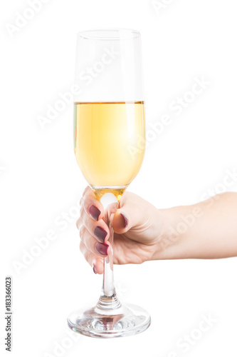 Woman hand holding a glass of expensive golden champagne