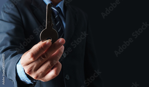 Close up of businessman holding the key to success concept