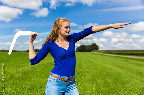 Young dutch woman throwing boomerang