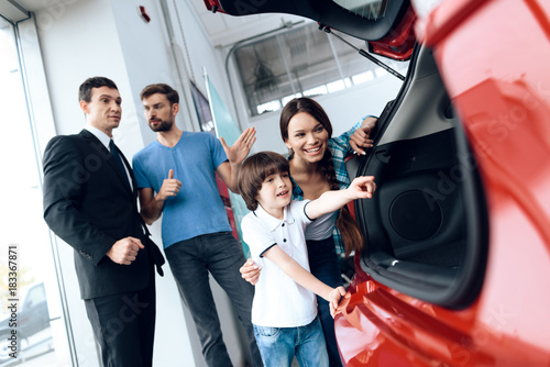A young family came to the car showroom to choose a new car. © VadimGuzhva