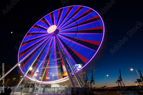 GENOA  ITALY  NOVEMBER 27  2017 - Ferris wheel with colored lights in  Porto Antico  harbor zone in Genoa  Italy