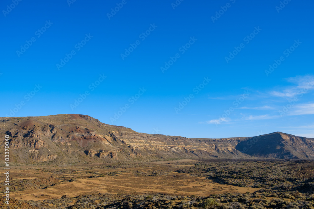 desert valley in mountain landscape , clear blue sky background