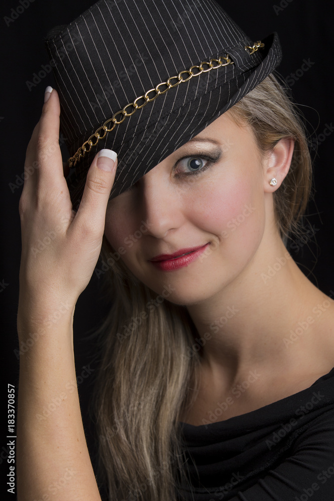 Portrait close-up of a beautiful blond woman with black hat Portrait close-up of a beautiful blond woman with black hat