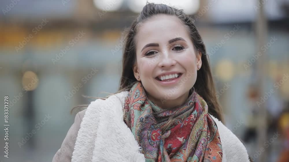 Young woman portrait in stylish look smiling in a city Young woman portrait in stylish look smiling in a city