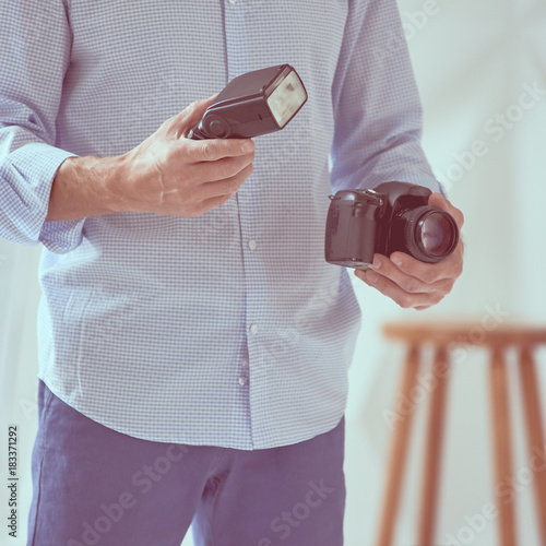 Man holding camera and flash photo