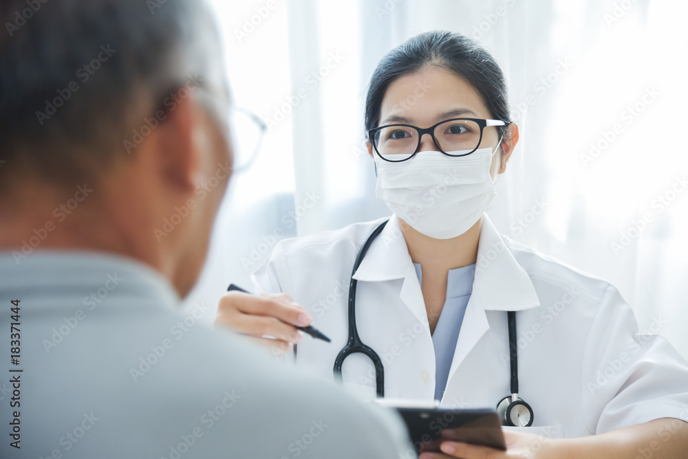 Asian Female Doctor talking to senior man patient. Asian Female Doctor talking to senior man patient.