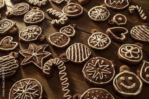 Traditional homemade Christmas ginger and chocolate cookies decorated with white sugar painting © Maygutyak