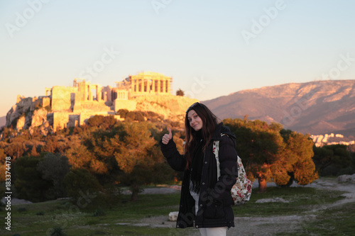 Young girl near fair sunset acropolis.Student in Athens,Greece.