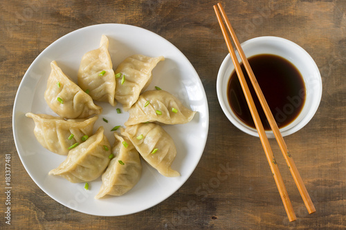 Eight boiled or fried jiaozi or gedza served with soy sauce.