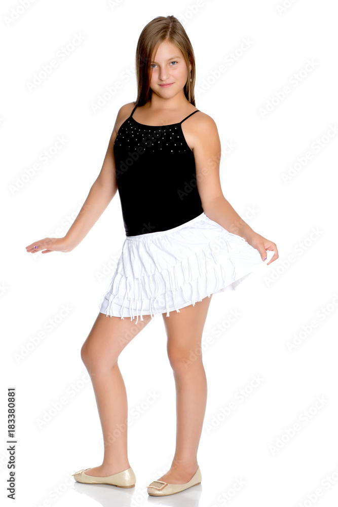 Fototapeta premium A teenage girl in a short white skirt and a black T-shirt.