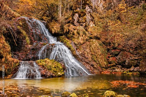Beautiful waterfall in forest, autumn scene.