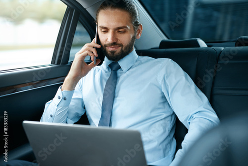 Business Man In Car Calling On Phone While Going To Work © puhhha