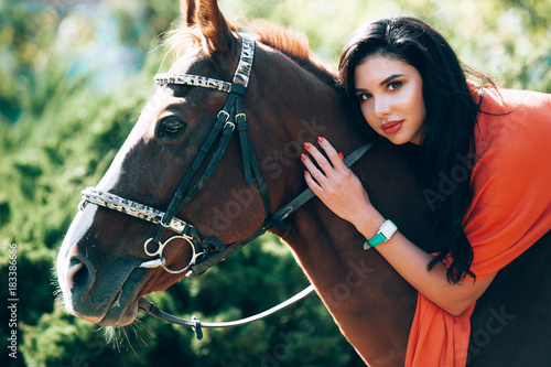 fashionable brunette with a racehorse