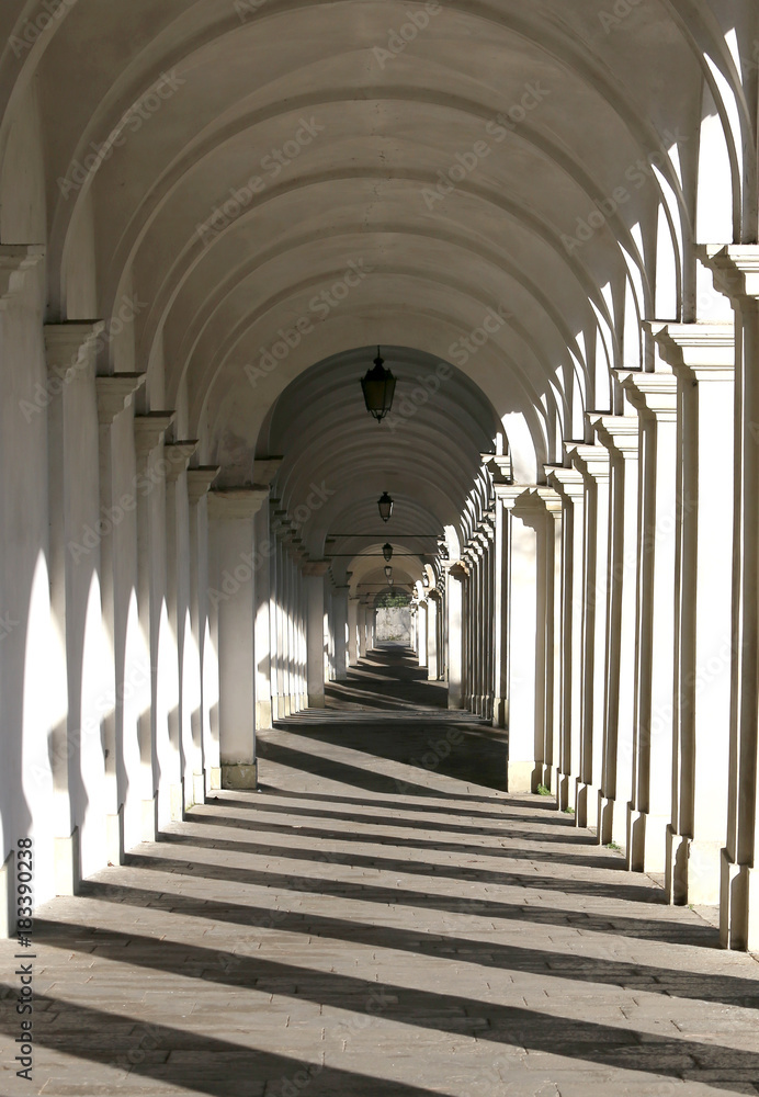 porch with arches in downhill with the shadows of columns