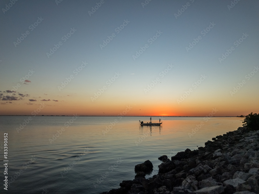 Men in a fishing boat at dusk
