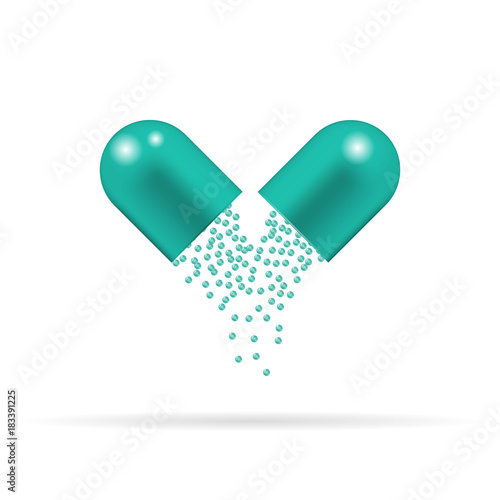 Capsule pill with green granules which are sprinkling and falling down. Tablet isolated on the white background.