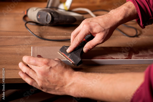 close up of carpenter hands working on wood