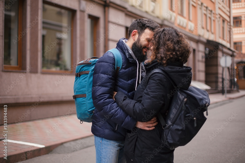 Young couple hugging and looking at each other on a city street. Young couple hugging and looking at each other on a city street.