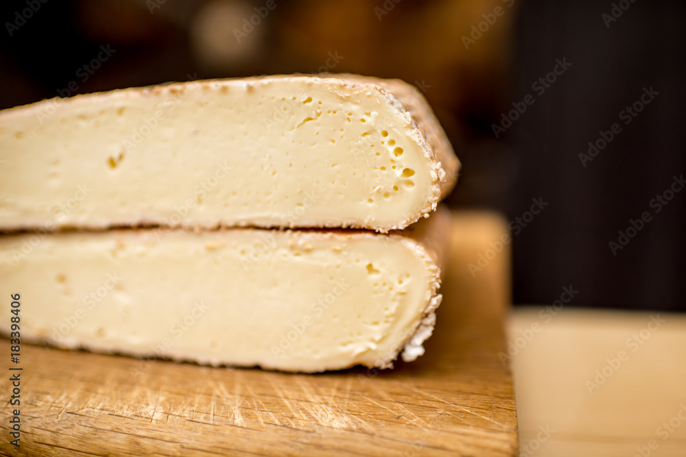 Close-up view on the slice of young soft cheese