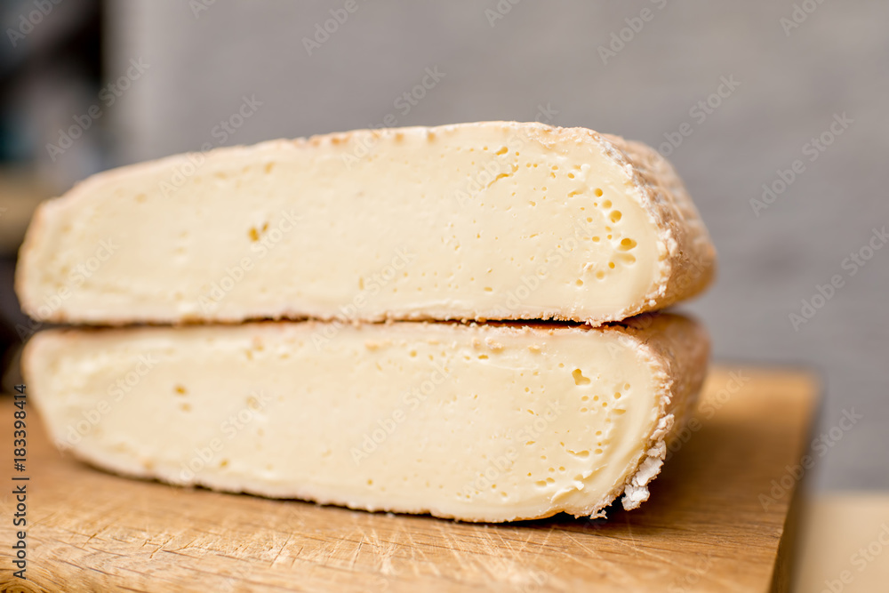 Close-up view on the slice of young soft cheese
