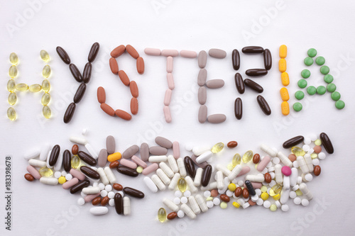 Conceptual Hand writing text caption inspiration Medical care Health concept written with pills drugs capsule word HYSTERIA season On white isolated background with copy space photo