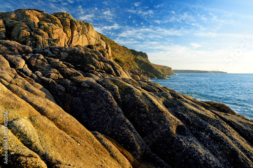 Rugged Cornish coastline at Porth Nanven on sunny evening, Cornwall, England photo