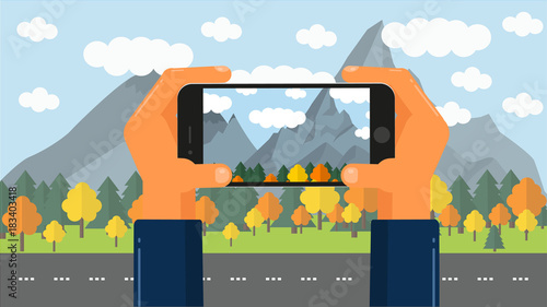 Hands take a video or take pictures of the landscape of the forest with mountains. photo in travel