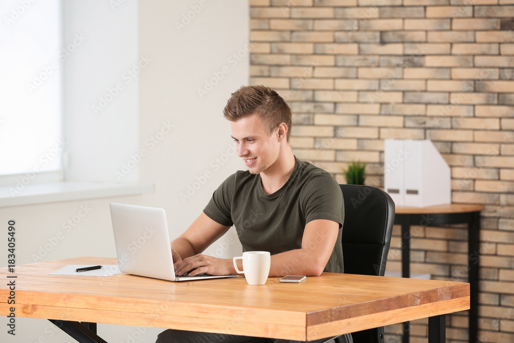 Handsome man with laptop in office Handsome man with laptop in office