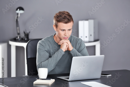 Serious man with laptop in ...