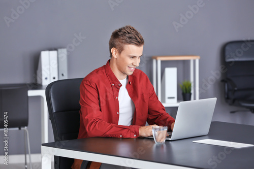 Handsome man with laptop in...