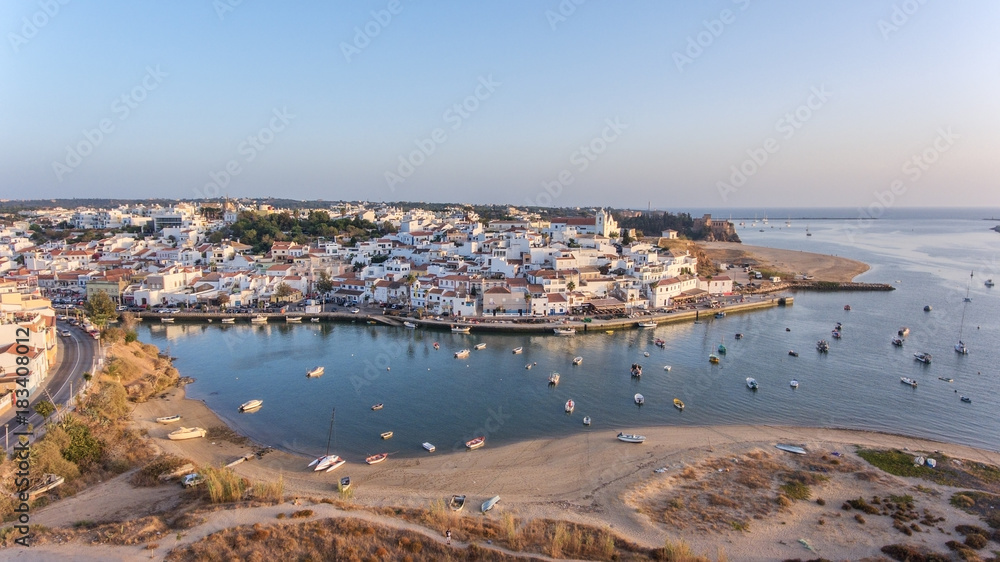 Aerial. Ferragudo at sunset shooting from the sky with drone. Portimao
