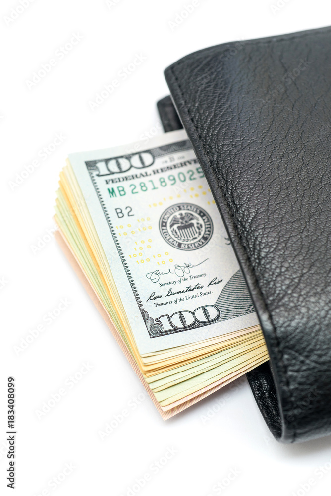 Stack of dollar bills sticking out of black wallet Stack of dollar bills sticking out of black wallet
