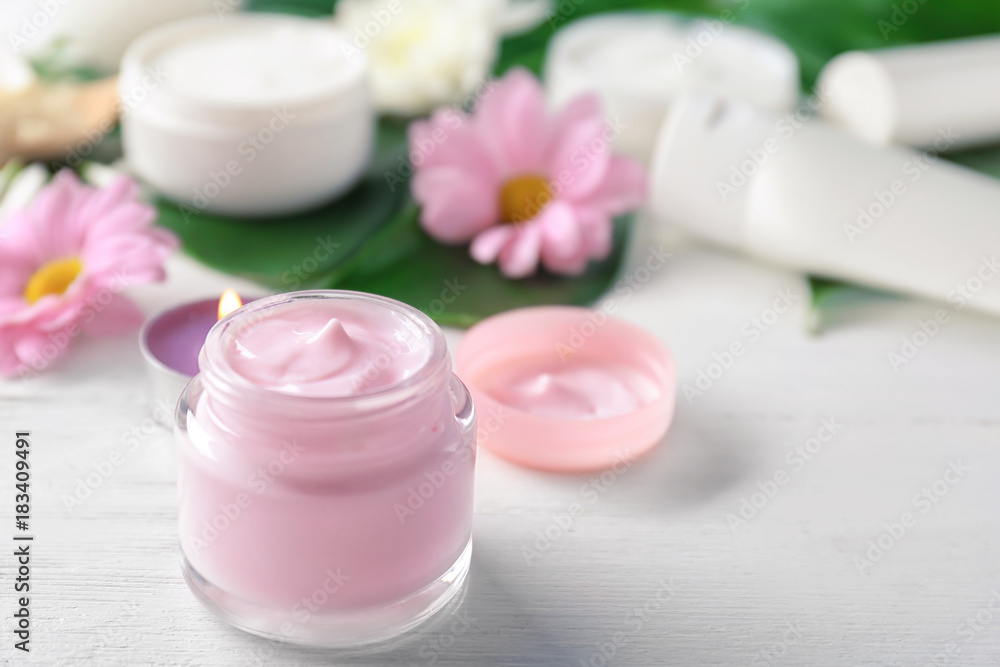 Jar with body cream on wooden table Jar with body cream on wooden table
