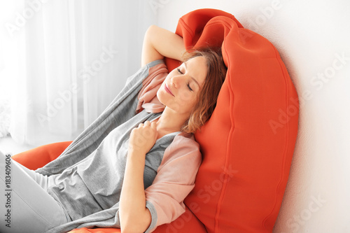 Happy young woman relaxing ...