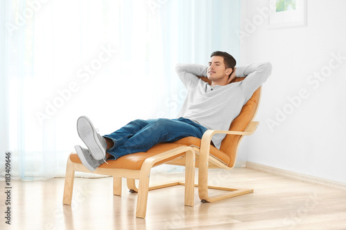 Happy young man relaxing at...