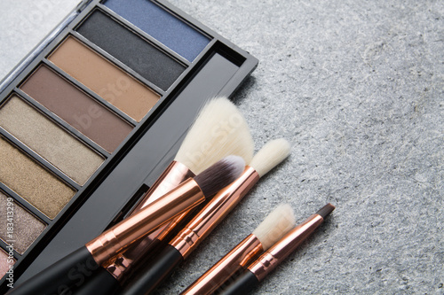 various makeup products on dark background