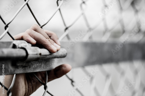 Obraz na plátne Woman hand holding on chain link fence for remember Human Rights Day concept