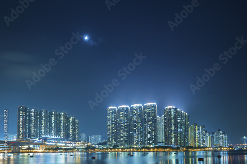 High rise residential building in Hong Kong Harbor at night