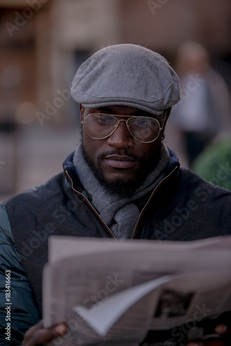Ethnic man Reading newspaper