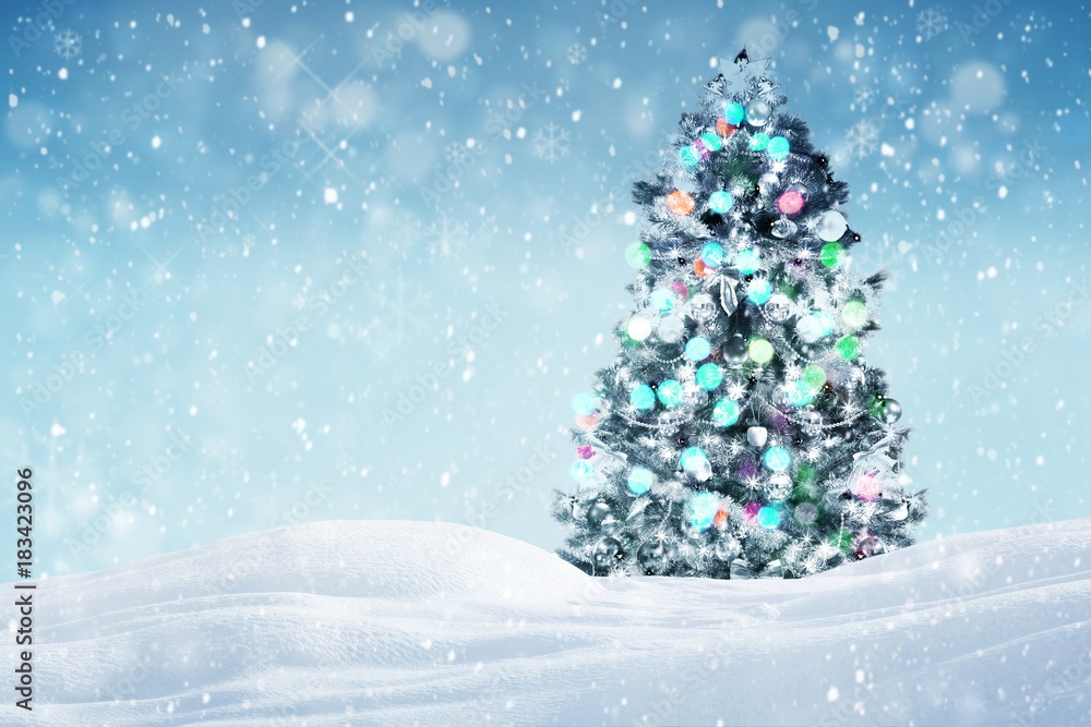 Decorated Christmas tree outdoors, falling snow winter holiday background