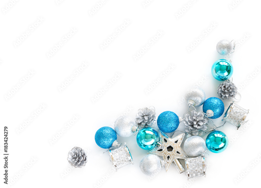 Christmas tree decorative ornaments of silver star, blue balls, pine cone and small drums over white background with copy space for Merry X'mas text insertion, logo or product decoration on new year Christmas tree decorative ornaments of silver star, blue balls, pine cone and small drums over white background with copy space for Merry X'mas text insertion, logo or product decoration on new year