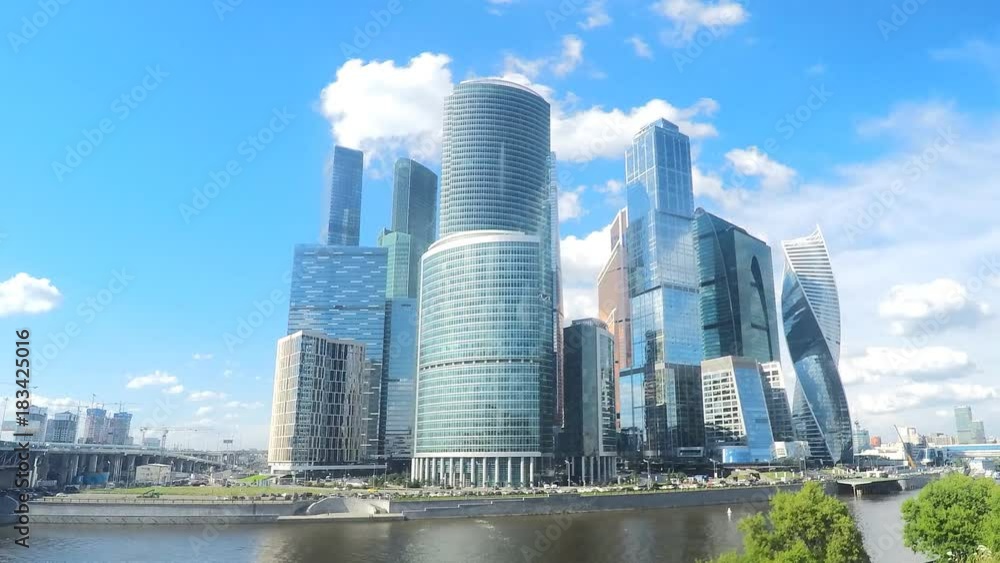 modern glass skyscrapers on the river bank in summer timelapse modern glass skyscrapers on the river bank in summer timelapse