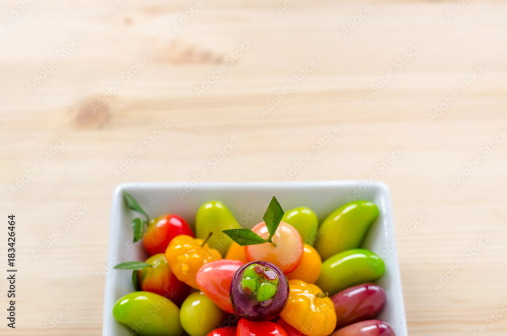 Thai dessert: deletable imitation fruits on the wooden background Thai dessert: deletable imitation fruits on the wooden background