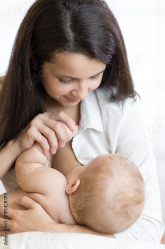 young mother breast feeding...
