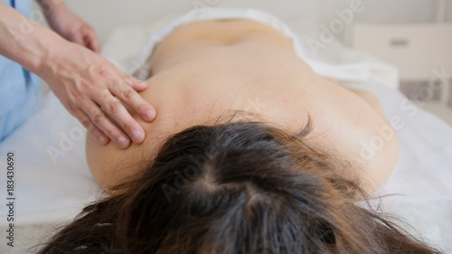 Young model woman model receiving massage at spa - healthcare concept